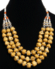 Collier ethnique artisanal trois rangs imitation pierres jaunes et perles agencées de pièces argentées ciselées Collier ethnique artisanal trois rangs imitation pierres jaunes et perles agencées de pièces argentées ciselées