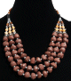 Collier ethnique artisanal trois rangs imitation pierres marrons et perles agencées de pièces argentées ciselées Collier ethnique artisanal trois rangs imitation pierres marrons et perles agencées de pièces argentées ciselées